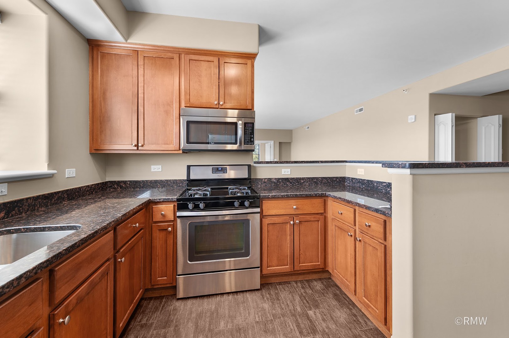 2 Itasca Place, Unit 419 Addison, IL 60143 - Photo 8 of 21 a kitchen with stainless steel appliances granite countertop a stove a sink and a microwave