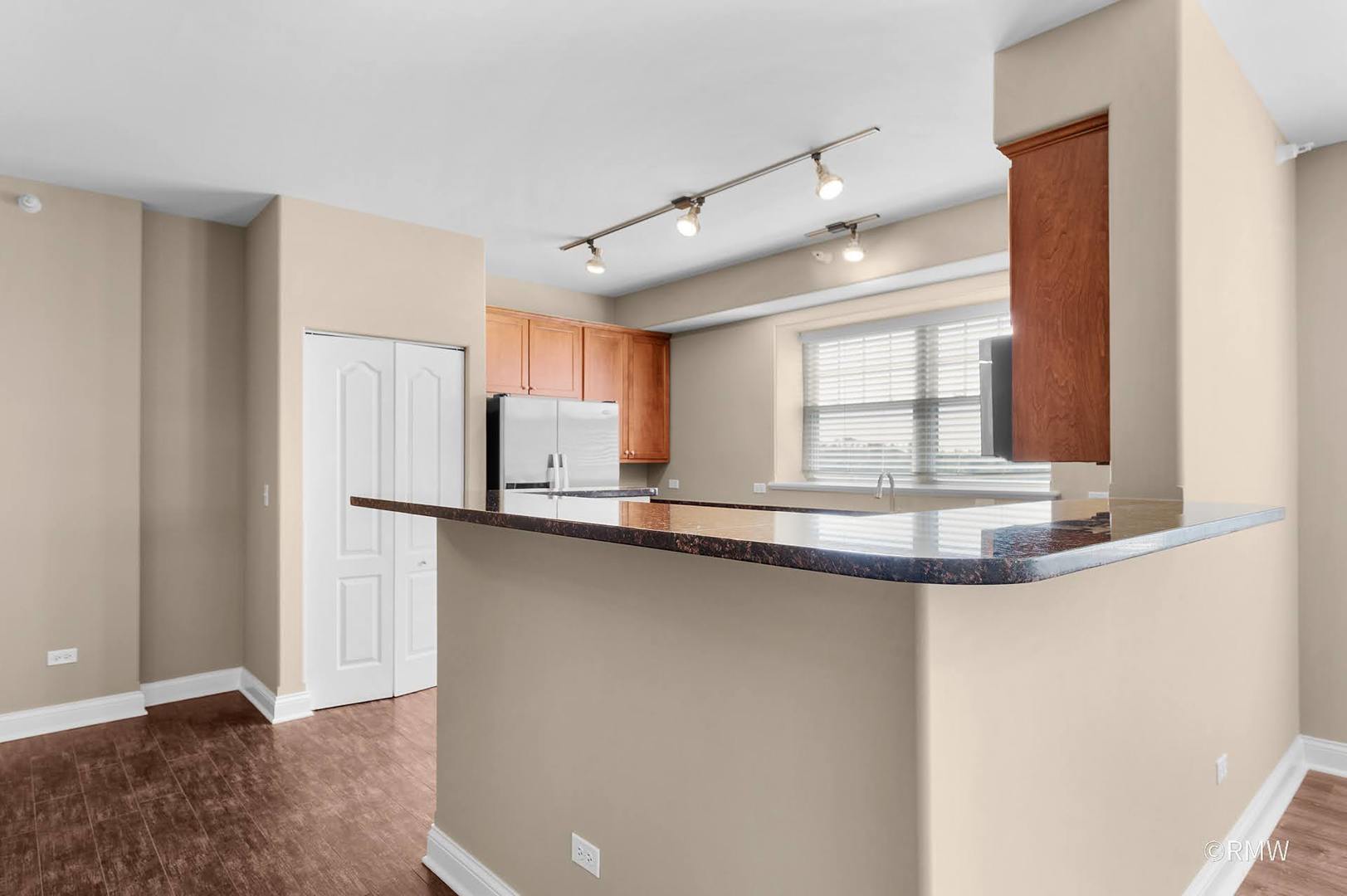 2 Itasca Place, Unit 419 Addison, IL 60143 - Photo 9 of 21 a kitchen with stainless steel appliances a sink and a window