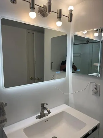 a bathroom with a sink and mirror