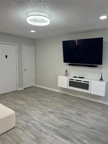 a view of living room with furniture and flat screen tv