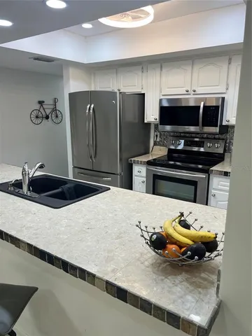 a kitchen with a sink and a stove