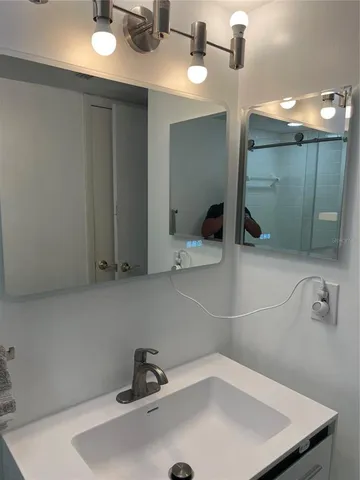 a bathroom with a sink and a mirror