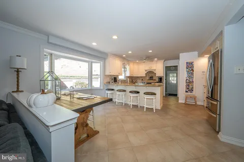 a kitchen with a sink and chairs