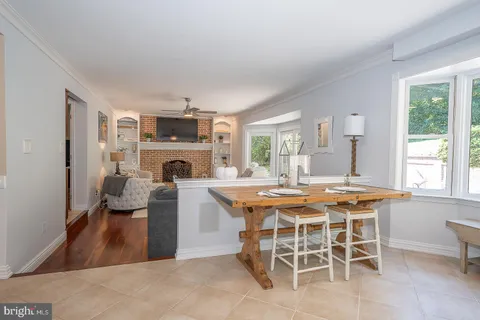 a dining room with furniture a window and a fireplace
