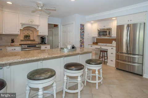 a kitchen with a sink cabinets and stainless steel appliances