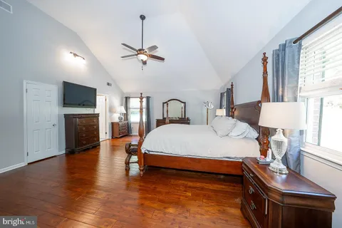 a bathroom with a tub a sink double vanity and a mirror