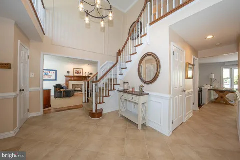 a view of a hallway with entryway and chandelier