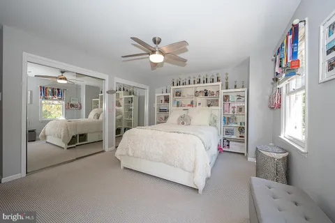a bedroom with a bed and a book shelf