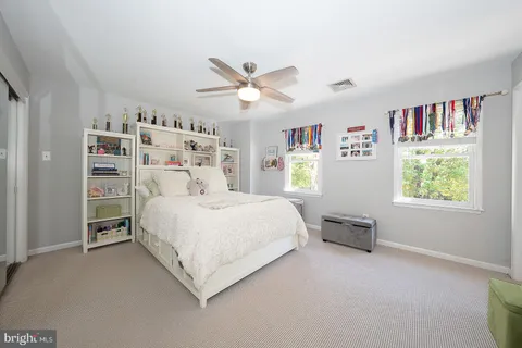 a bedroom with a bed dresser and a window
