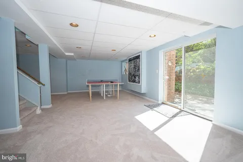 a room with gym equipment and a flat screen tv