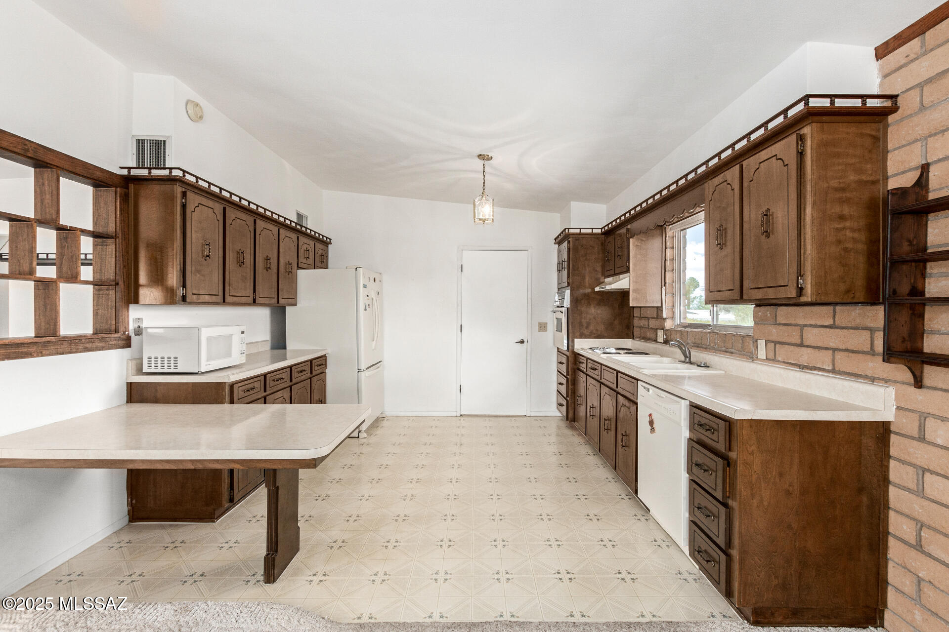 16381 South Observatory Place Vail, AZ 85641 - Photo 7 of 23 a kitchen with stainless steel appliances granite countertop a sink stove and refrigerator