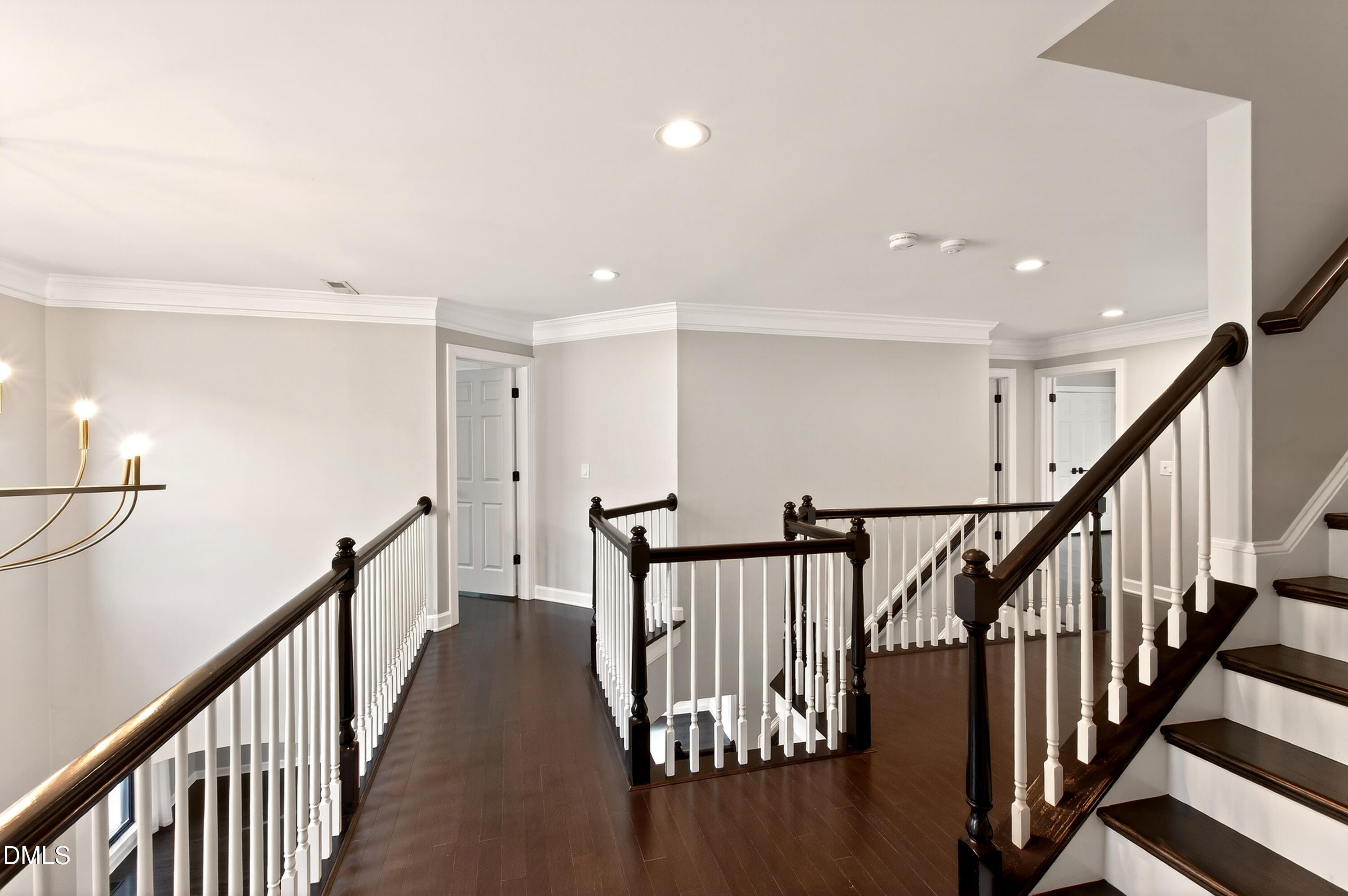 12408 Cilcain Court Raleigh, NC 27614 - Photo 36 of 80 a view of staircase with lots of frames on wall and wooden floor