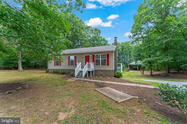 a view of a house with a yard porch and sitting area