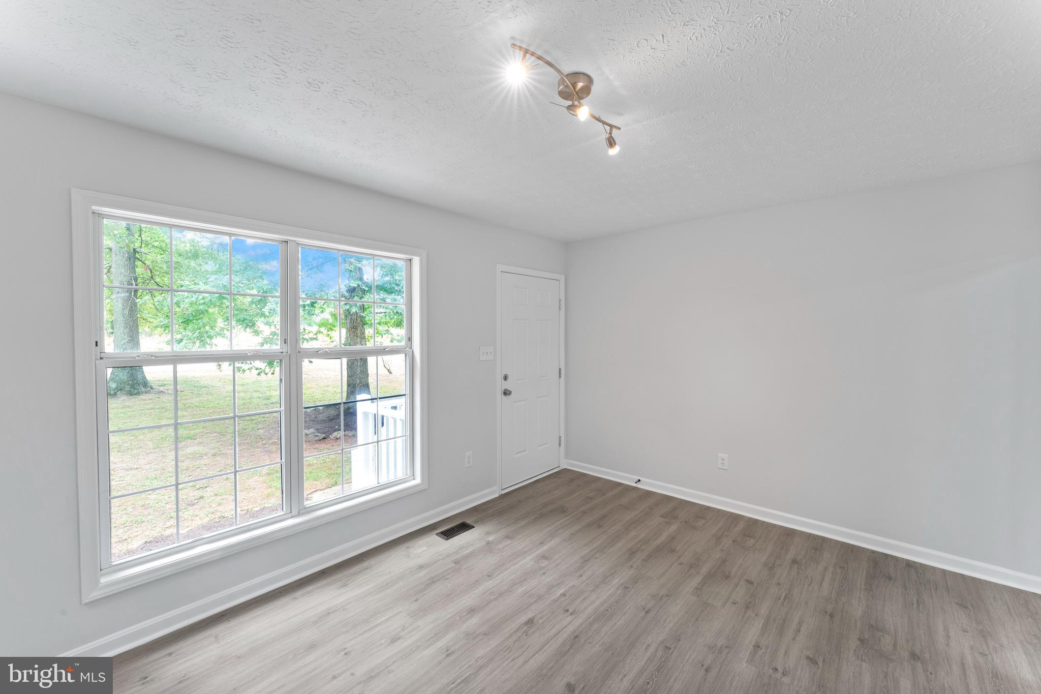1543 Vawter Corner Road Louisa, VA 23093 - Photo 18 of 43 wooden floor in an empty room with a window