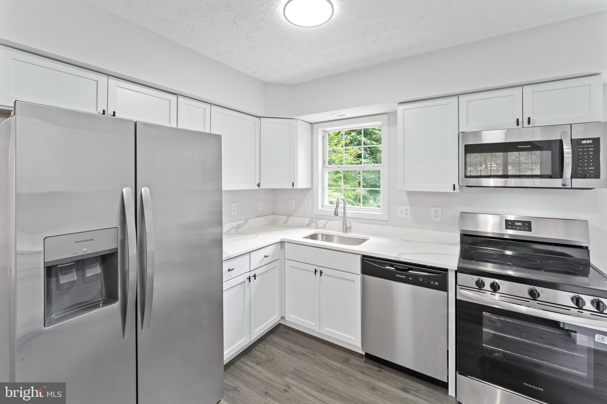 1543 Vawter Corner Road Louisa, VA 23093 - Photo 22 of 43 a kitchen with stainless steel appliances a refrigerator sink and microwave