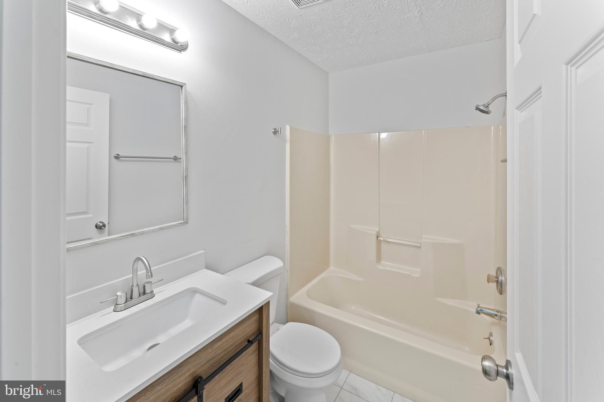 1543 Vawter Corner Road Louisa, VA 23093 - Photo 27 of 43 a bathroom with a sink toilet vanity and shower