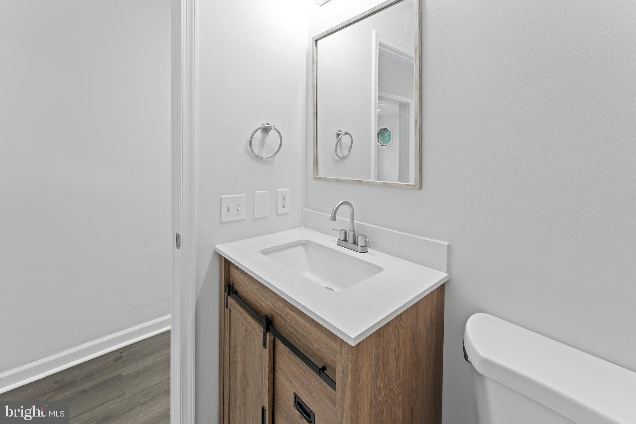 1543 Vawter Corner Road Louisa, VA 23093 - Photo 28 of 43 a bathroom with a sink a toilet and mirror
