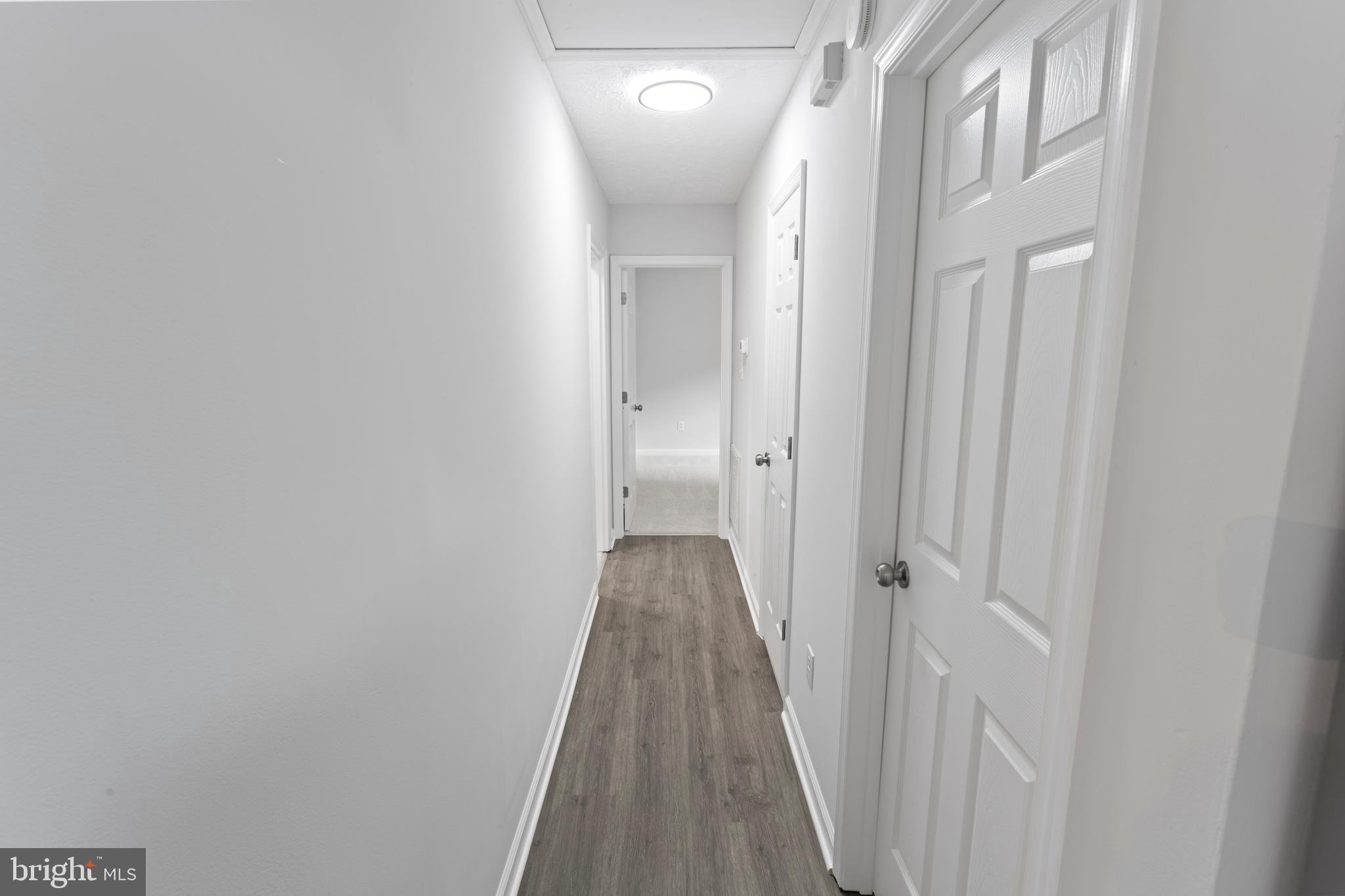 1543 Vawter Corner Road Louisa, VA 23093 - Photo 29 of 43 a view of a hallway with wooden floor and closet area