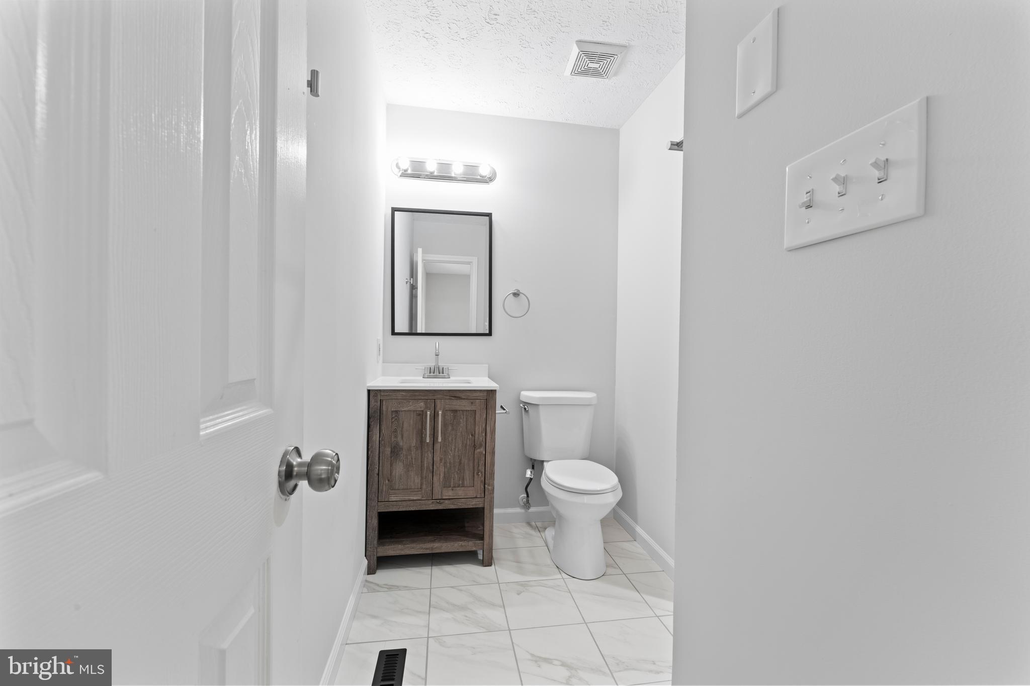 1543 Vawter Corner Road Louisa, VA 23093 - Photo 35 of 43 a bathroom with a toilet a sink and mirror