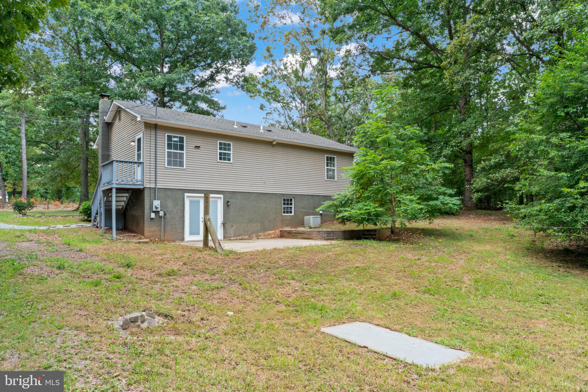 1543 Vawter Corner Road Louisa, VA 23093 - Photo 10 of 43 a front view of a house with a yard and garage