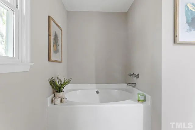 a white bath tub sitting next to a white sink