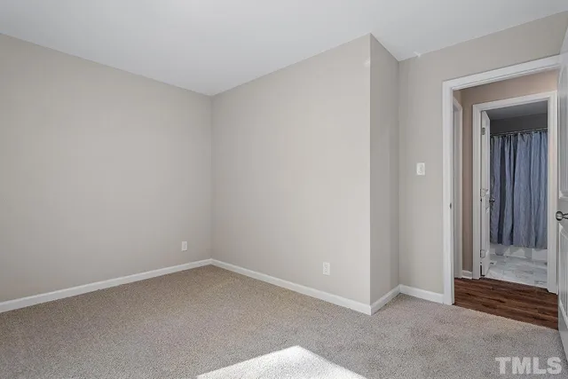 a bathroom with a granite countertop bathtub sink vanity mirror and toilet