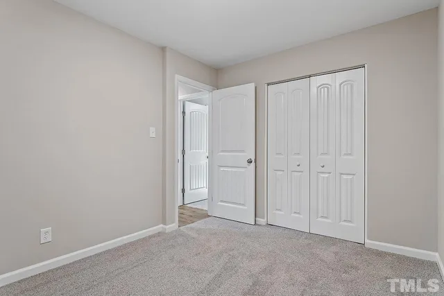 an empty room with windows and entrance