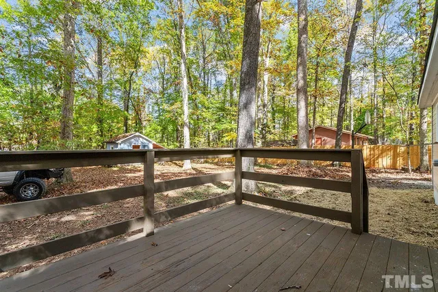 a view of a small house with a yard