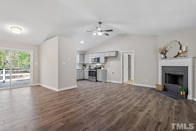a view of a kitchen with a sink and a fireplace