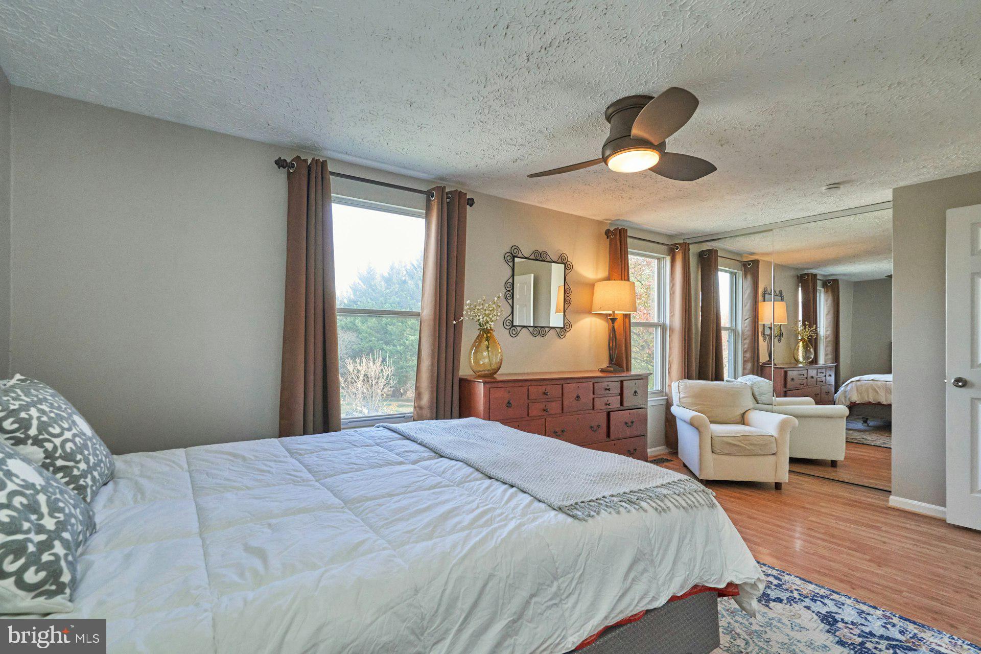 1750 Sundance Drive Reston, VA 20194 - Photo 17 of 36 a bedroom with a large bed and wooden floor