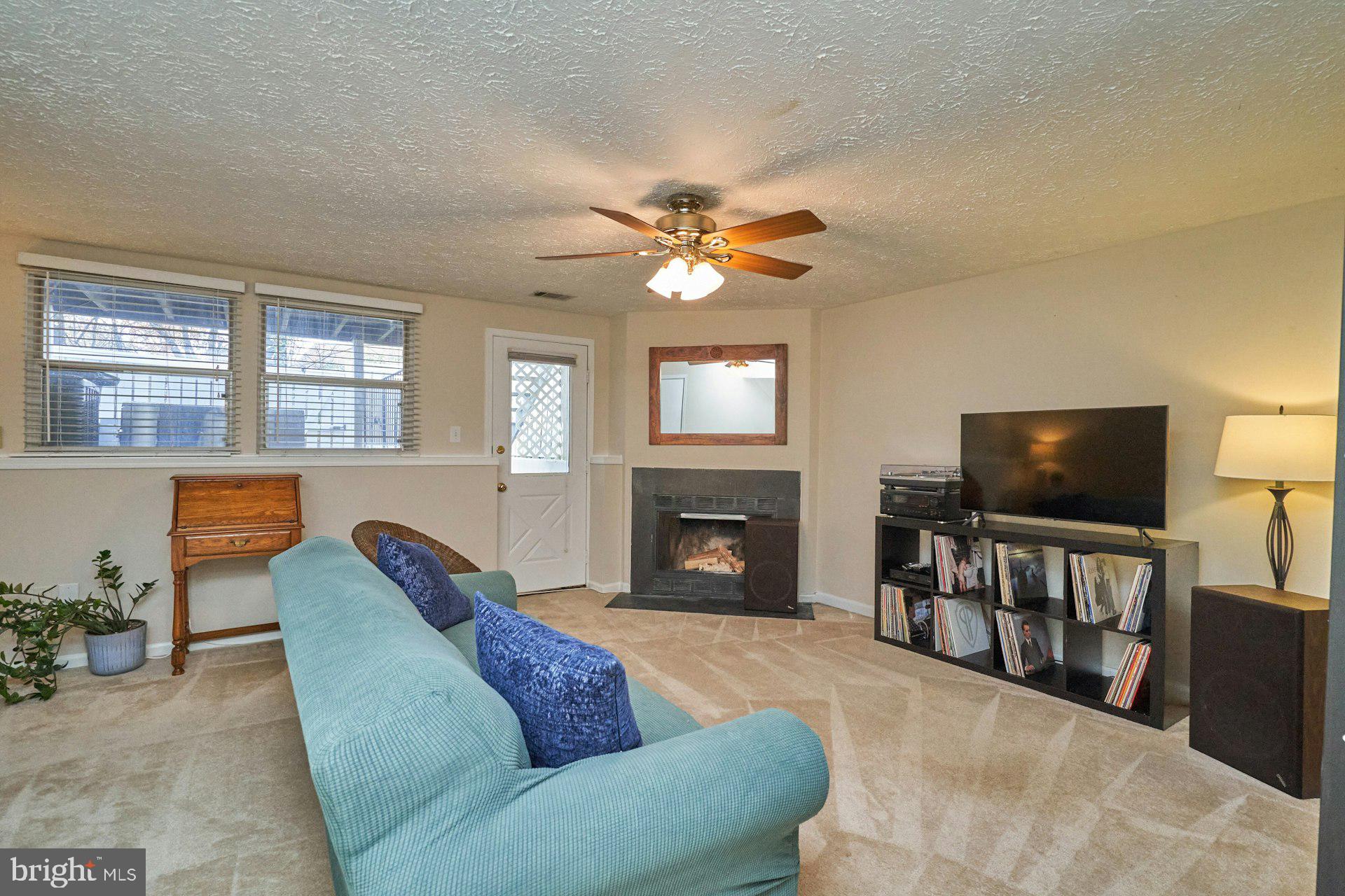 1750 Sundance Drive Reston, VA 20194 - Photo 24 of 36 a living room with furniture a fireplace and a flat screen tv