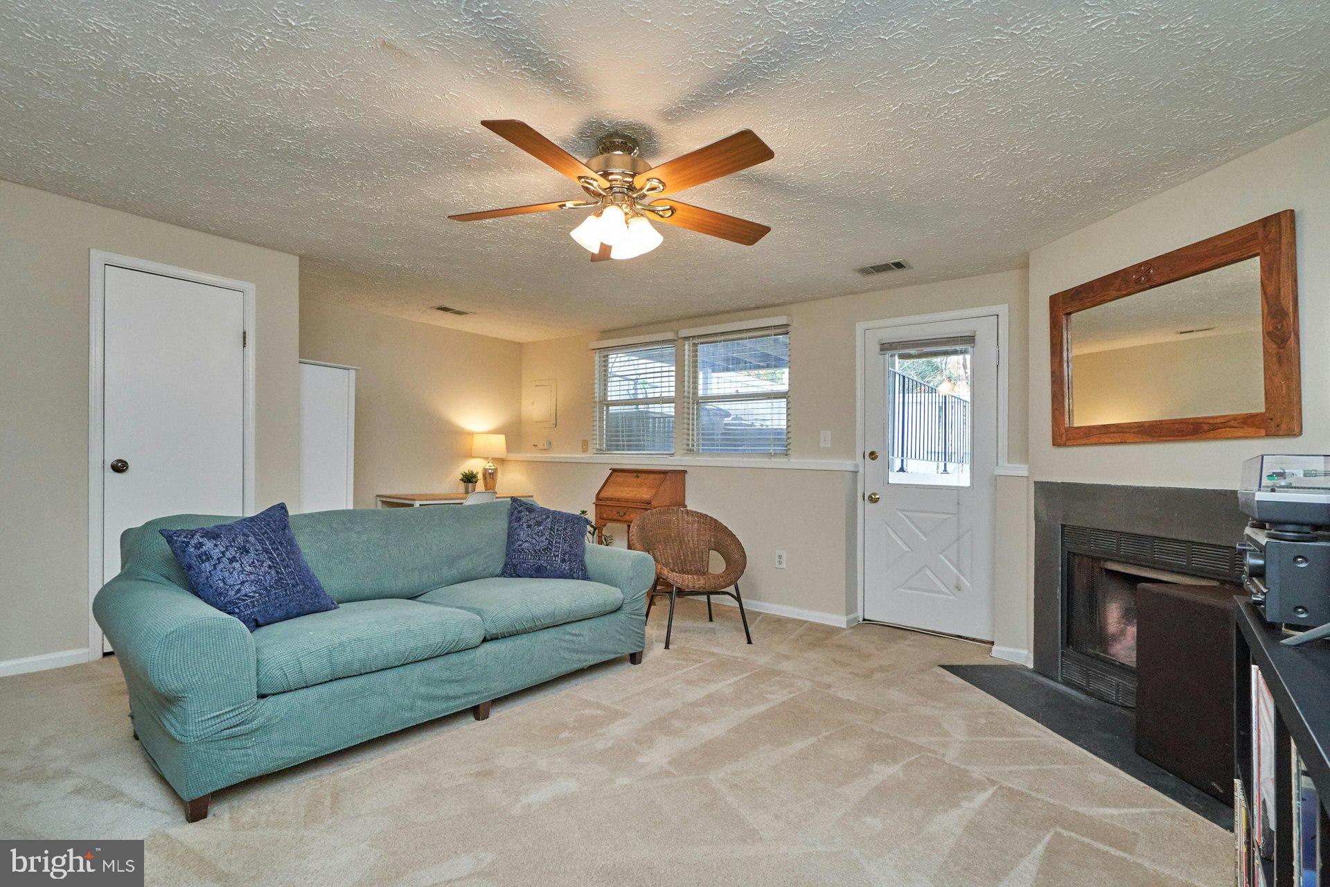 1750 Sundance Drive Reston, VA 20194 - Photo 25 of 36 a living room with furniture a fireplace and a window