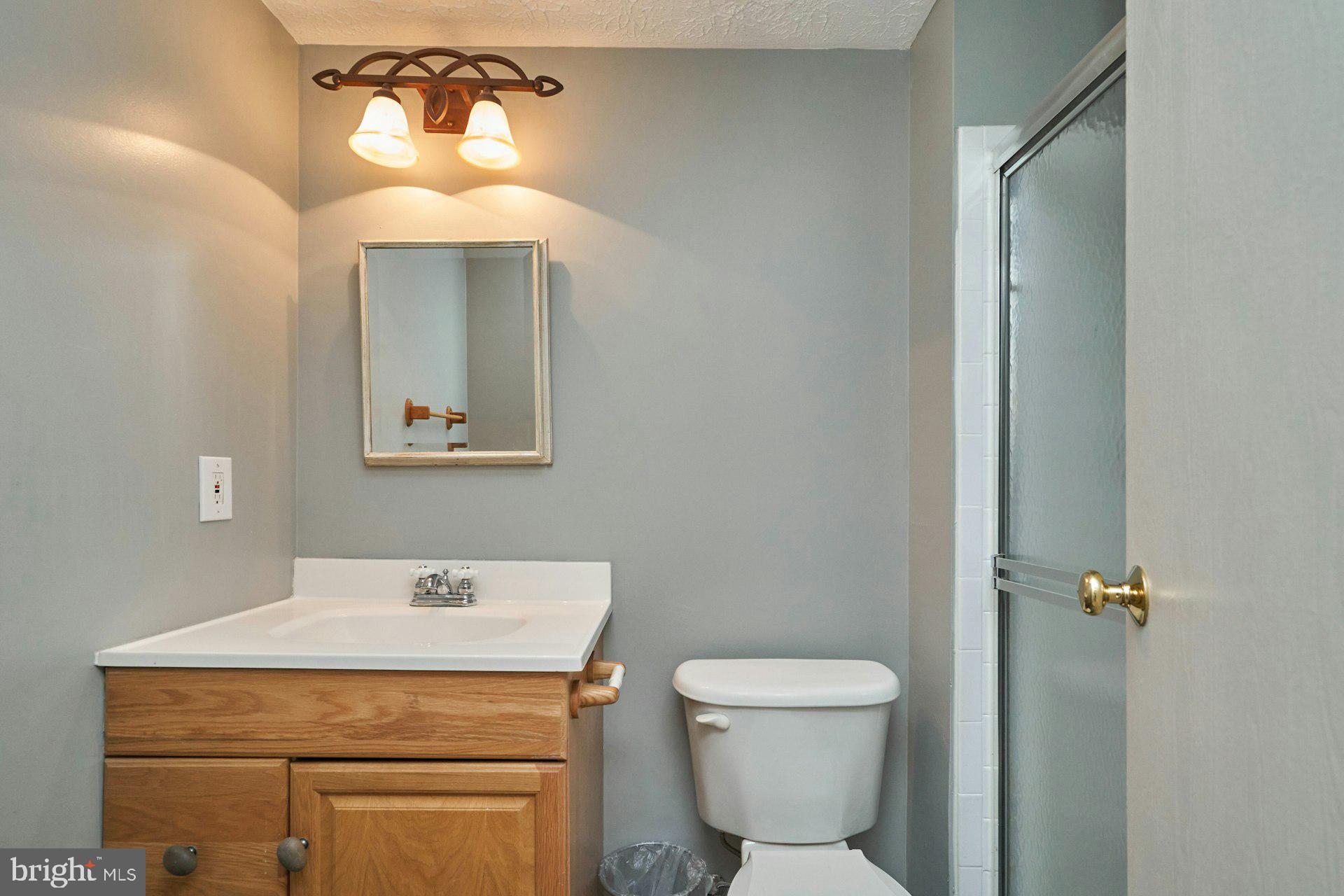 1750 Sundance Drive Reston, VA 20194 - Photo 27 of 36 a bathroom with a toilet sink and mirror