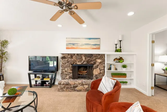 a living room with furniture and a fireplace