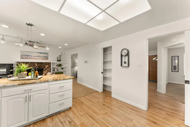a view of a kitchen with cabinets and wooden floor