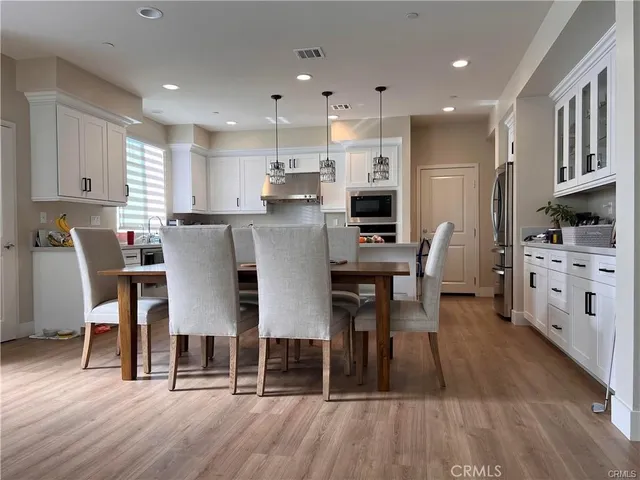 a dining room with furniture and wooden floor