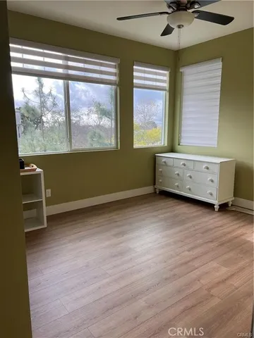 a view of room with window and wooden floor