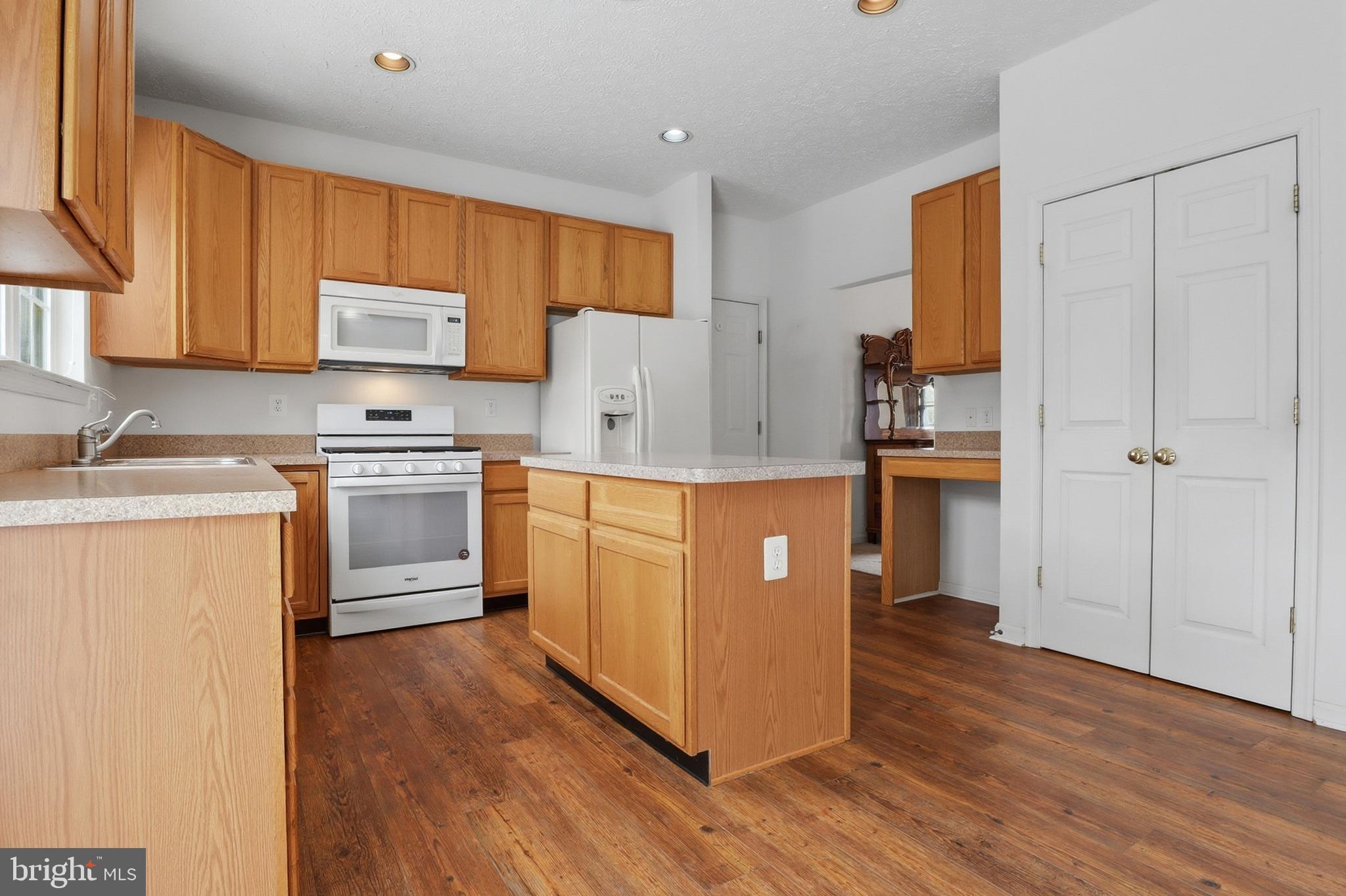 233 Sunset Circle Red Lion, PA 17356 - Photo 9 of 54 a kitchen with cabinets wooden floor and stainless steel appliances