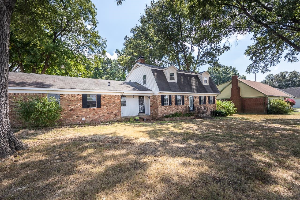 2718 Kate Bond Road Memphis, TN 38133 - Photo 37 of 39 Dutch colonial with brick siding, a gambrel roof, a front lawn, a shingled roof, and a chimney