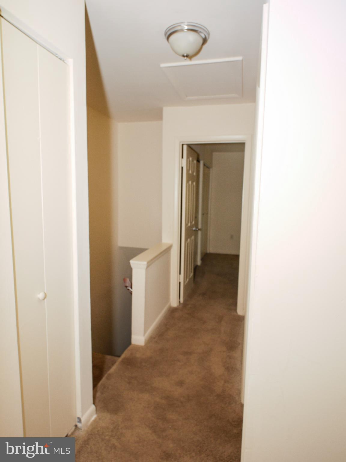 6661 Spring Mill Circle Baltimore, MD 21207 - Photo 13 of 22 a view of a hallway with a white walls