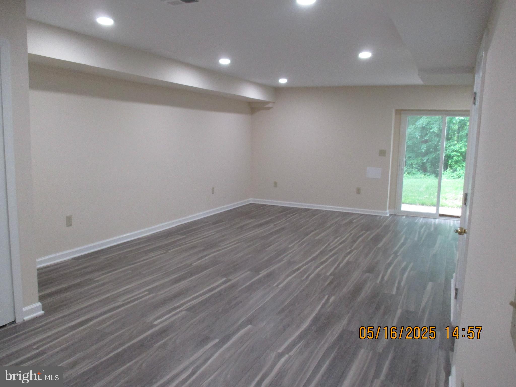 6661 Spring Mill Circle Baltimore, MD 21207 - Photo 17 of 22 an empty room with wooden floor and windows
