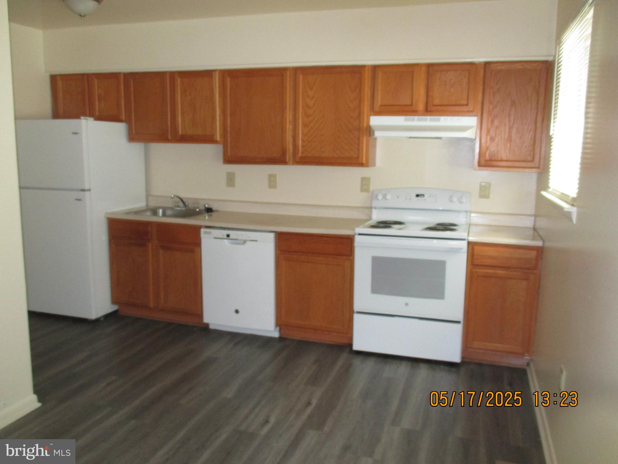 6661 Spring Mill Circle Baltimore, MD 21207 - Photo 4 of 22 a kitchen with a cabinets and white appliances