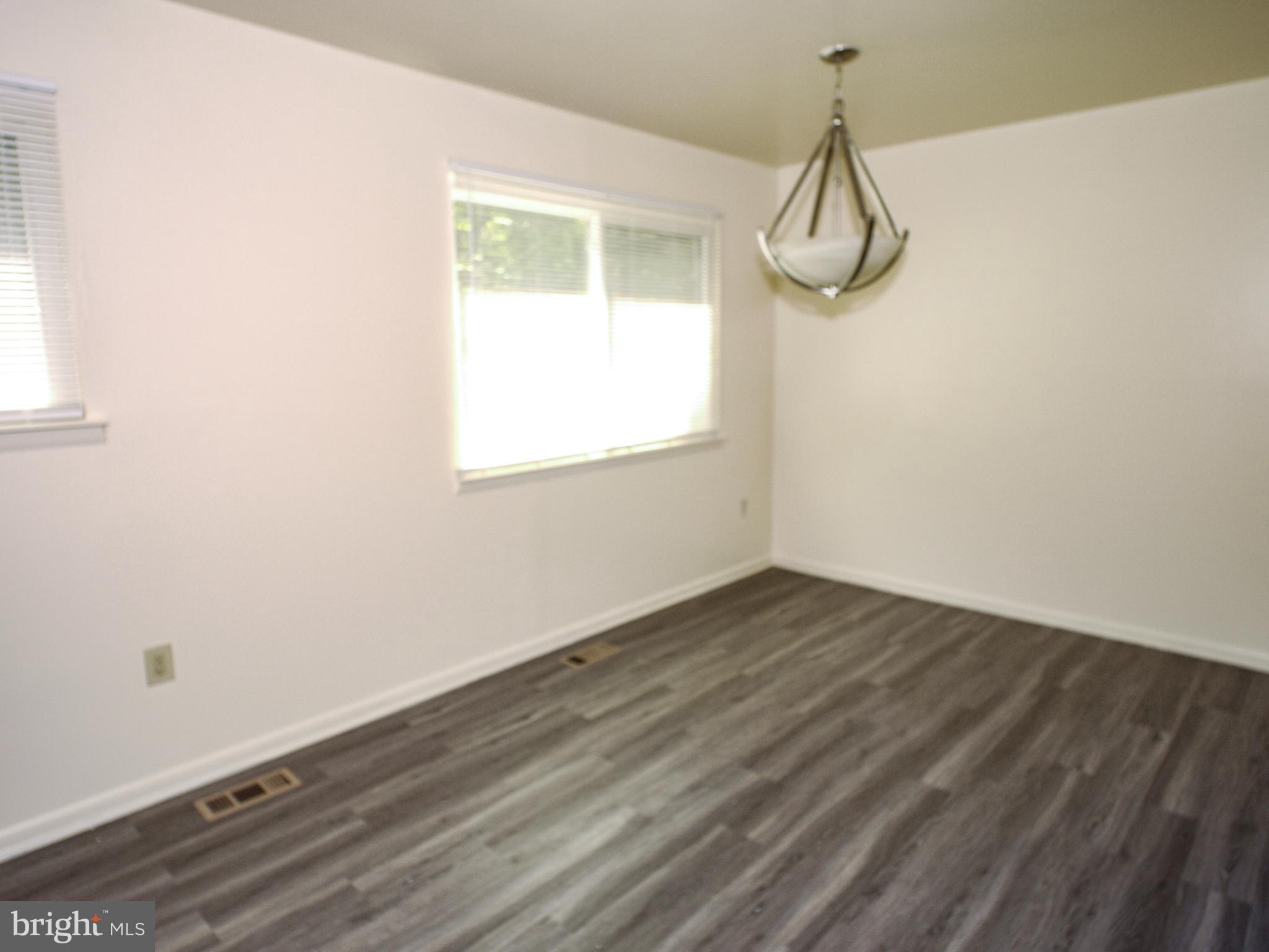 6661 Spring Mill Circle Baltimore, MD 21207 - Photo 5 of 22 a view of a room with wooden floor and windows