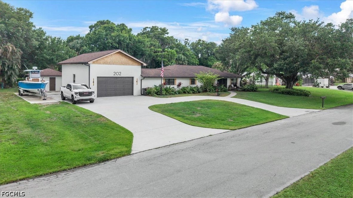 202 Ridgewood Avenue Clewiston, FL 33440 - Photo 3 of 50 a view of a house with a yard and sitting area