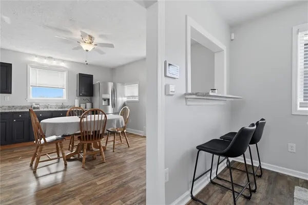 a view of a dining room with furniture and wooden floor