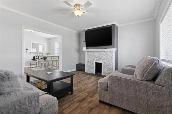 a living room with furniture fireplace and flat screen tv