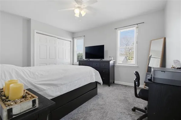 a bedroom with a bed a window and piano