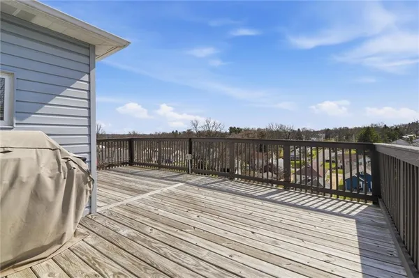 a view of a balcony with wooden floor and city view