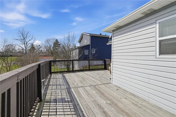 a view of wooden balcony and trees