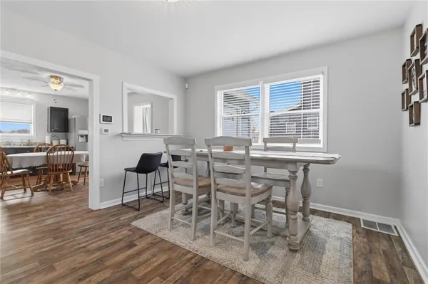 a view of a dining room with furniture and wooden floor